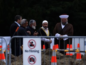 Mourners gather before a service of a victim from last week's mosque shooting for a burial at the Memorial Park Cemetery in Christchurch, New Zealand, Thursday, March 21, 2019.