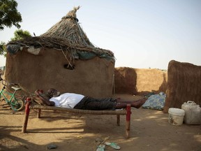 FILE - In this Oct. 7, 2016 file photo, a man rests on a bed in front of his hut at a camp for internally displaced people near the town of Abs, in the Hajjah governorate, of Yemen. The U.N. Office for the Coordination of Humanitarian Affairs, or OCHAU.N. warned in a report Tuesday, March 12, 2019, that thousands of Yemeni civilians caught in fierce clashes between warring factions are trapped in the embattled northern district of Hajjah. The number of displaced in the district has doubled over the past six months, the humanitarian agency said.