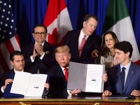 Prime Minister Justin Trudeau, right to left, Foreign Affairs Minister Chrystia Freeland, United States Trade Representative Robert Lighthizer, President of the United States Donald Trump, Mexico's Secretary of Economy Ildefonso Guajardo Villarreal, and President of Mexico Enrique Pena Nieto participate in a signing ceremony for the new United States-Mexico-Canada Agreement in Buenos Aires, Argentina on Friday, Nov. 30, 2018.