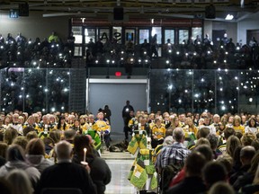 Members of the community joined with families of those killed and lit up their phones during the Humboldt Broncos memorial service at Elgar Petersen Arena in Humboldt, SK on Saturday, April 6, 2019.