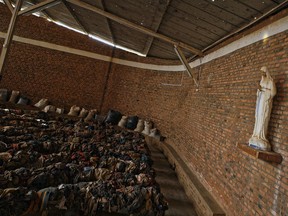 Piles of clothes belonging to some of those who were slaughtered as they sought refuge inside the church cover the pews as a memorial to the thousands who were killed during the 1994 genocide in and around the Catholic church in Nyamata, Rwanda.