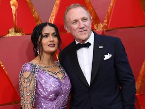 Actress Salma Hayek (L) and her husband French entrepreneur Francois-Henri Pinault arrive for the 90th Annual Academy Awards on March 4, 2018, in Hollywood, California.