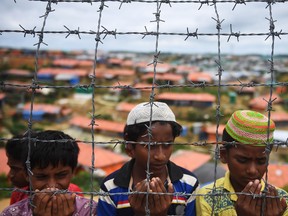 Rohingya refugees pray as they remember a military crackdown that prompted a massive exodus of people from Myanmar to Bangladesh.