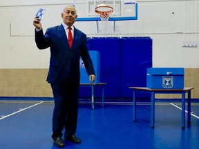 Israeli Prime Minister Benjamin Netanyahu casts his vote during Israel's parliamentary elections in Jerusalem, on April 9, 2019.
