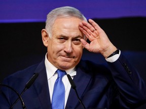 Israeli Prime Minister Benjamin Netanyahu  addresses supporters at his Likud Party headquarters in the Israeli coastal city of Tel Aviv on election night early on April 10, 2019.