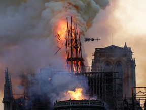 The steeple collapses as smoke and flames engulf the Notre-Dame Cathedral in Paris on April 15, 2019.