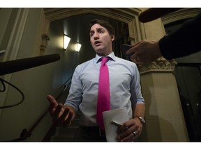 Prime Minister Justin Trudeau speaks with the media as he makes his way to caucus in the West Block, Wednesday, April 10, 2019 in Ottawa.