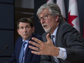 British Columbia Privacy Commissioner Michael McEvoy looks on as Canada's Privacy Commissioner Daniel Therrien (right) speaks during a news conference, Thursday, April 25, 2019 in Ottawa.