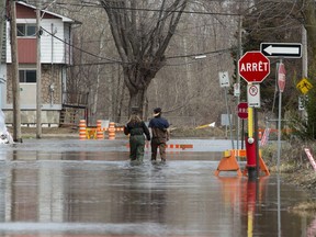 Local residents make their way through flood waters in Gatineau, Que., Tuesday, April 23, 2019.