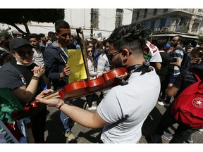 Students carry banners and chant slogans during a demonstration in Algiers, Algeria, Tuesday, April 16, 2019. President of the Algerian Constitutional Council Tayeb Belaiz resigned on Tuesday amid mass protests in the country demanding for his departure. "Belaiz notified the members of the Constitutional Council, during a meeting held Tuesday, that he presented his resignation to the interim president Abdelkader Bensalah," the council said in a statement.