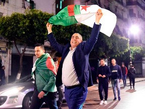 Algerians celebrate following the resignation of veteran president Abdelaziz Bouteflika on April 2, 2019.