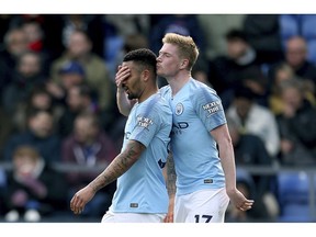 Manchester City's Gabriel Jesus, left, celebrates scoring his side's third goal of the game with teammate Kevin De Bruyne, during the English Premier League soccer match between Crystal Palace and Manchester United,  at Selhurst Park, in London, Sunday April 14, 2019.
