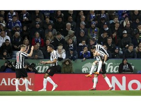 Newcastle United's Ayoze Perez bottom right celebrates scoring his side's first goal of the game, during the English Premier League soccer match between Leicester City and Newcastle United, at The King Power Stadium, in  Leicester England, Friday April 12, 2019.