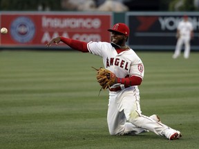 Los Angeles Angels second baseman Luis Rengifo makes a throw from his knees after a ground ball from New York Yankees' Tyler Wade during the third inning of a baseball game Thursday, April 25, 2019, in Anaheim, Calif. Wade was safe at first base with an infield single.