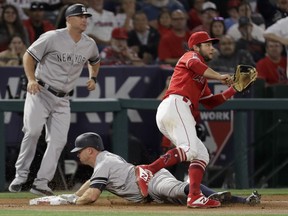 New York Yankees' Brett Gardner is safe past Los Angeles Angels third baseman David Fletcher after a triple during the third inning of a baseball game in Anaheim, Calif., Tuesday, April 23, 2019.