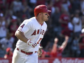 Los Angeles Angels' Mike Trout watches his two-run home run during the sixth inning against the Texas Rangers in a baseball game Sunday, April 7, 2019, in Anaheim, Calif.