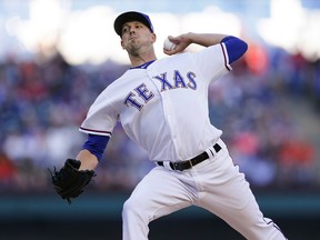 Texas Rangers starting pitcher Drew Smyly throws during the first inning of the team's baseball game against the Houston Astros, Friday, April 19, 2019, in Arlington, Texas.