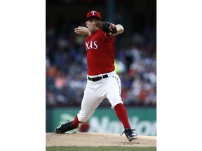 CORRECTS TO APRIL 20 NOT APRIL 19 - Texas Rangers starting pitcher Adrian Sampson delivers against the Houston Astros during the first inning of a baseball game Saturday, April 20, 2019, in Arlington, Texas.