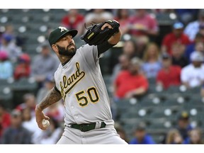 Oakland Athletics starting pitcher Mike Fiers works against the Texas Rangers during the first inning of a baseball game Friday, April 12, 2019, in Arlington, Texas.