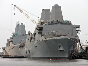 The USS Arlington, front, and USS San Diego, rear, both U.S. Navy amphibious transport dock ships, sit at the dock at Ingalls Shipbuilding yard, a division of Huntington Ingalls Industries Inc., in Pascagoula, Mississippi, U.S., on Tuesday, June 7, 2011. The U.S. Navy has launched an investigation into the discovery of a hidden camera in the women's bathroom aboard the USS Arlington last month, three military officials told NBC News.