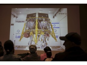 People watch the live broadcast of the SpaceIL spacecraft as it lost contact with Earth in Netanya, Israel, Thursday, April 11, 2019. An Israeli spacecraft has failed in its attempt to make history as the first privately funded lunar mission.The SpaceIL spacecraft lost contact with Earth late Thursday, just moments before it was to land on the moon, and scientists declared the mission a failure.