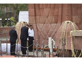 British High Commissioner to India Dominic Asquith, second left, pays homage to commemorate century of the Jallianwala Bagh incident, in Amritsar, India, Saturday, April 13, 2019. On April 13, 1919, hundreds were killed and more than 1,200 injured after British troops led by Reginald Dyer opened fire on a peaceful gathering at Jallianwala Bagh in Amritsar.