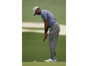 Tiger Woods putts on the 10th hole during a practice round for the Masters golf tournament Monday, April 8, 2019, in Augusta, Ga.