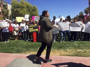 FILE - This April 10, 2019, file photo shows supporters of three University of Arizona students who were charged with a misdemeanor for their part in a protest of two Border Patrol agents on the university's Tucson campus. The charges were dismissed Friday at the request of prosecutors after they learned the university will conduct an administrative investigation into the March 19 protest in Tucson.