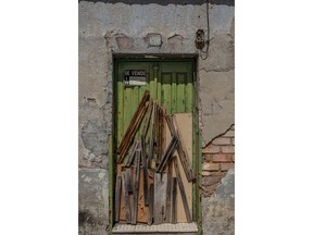 In this April 10, 2019, photo, a sealed door of a house for sale in Puertollano, near Ciudad Real, central Spain. Spanish politicians are swapping campaign buses for tractors, buddying up with hunters and inspecting home-grown tomatoes in Spain's often-neglected rural regions as they hunt for votes in Sunday's general election, one of the country's most polarized votes in decades.