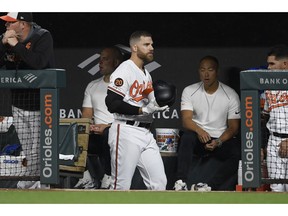 CORRECTS TO SECOND INNING NOT FIRST INNING - Baltimore Orioles' Chris Davis walks in the dugout after he lined out during the second inning of a baseball game against the Oakland Athletics, Monday, April 8, 2019, in Baltimore.