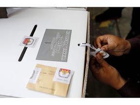 An Indonesian electoral worker prepares a ballot box to be distributed to polling stations in Bali, Indonesia, Saturday, April 13, 2019. The world's third-largest democracy is gearing up to hold its legislative and presidential elections on April 17.