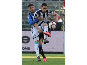 Atalanta's Jose Palomino, left, and Udinese's Kevin Lasagna vie for the ball during a Serie A soccer match between Atalanta and Udinese at the Atleti Azzurri d'Italia stadium in Bergamo, Italy, Monday, April 29, 2019.