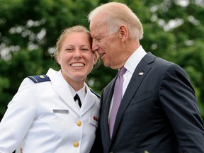 In this May 22, 2013 file photo, Newly commissioned officer Erin Talbot, left, poses for a photograph with Vice President Joe Biden during commencement for the United States Coast Guard Academy in New London, Conn.