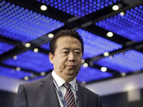 FILE - In this July 4, 2017, file photo, Interpol President, Meng Hongwei, walks toward the stage to deliver his opening address at the Interpol World Congress in Singapore. China has formally arrested Meng on suspicion of accepting bribes. The Supreme People's Procuratorate announced the indictment on Wednesday.