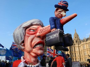 Anti-Brexit activists demonstrate with a model of Theresa May outside the Houses of Parliament in London on Monday.