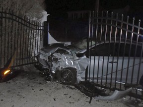This Tuesday, April 2, 2019 photo released by the Hopkinton, R.I., Police Department shows a car after it crashed into the gates of singer Taylor Swift's beachfront home in Westerly, R.I. Police said the car was stolen in Hartford, Conn., and that officers from Hopkinton and Westerly pursued the vehicle with four occupants around 1 a.m. Tuesday. (Hopkinton Police Department via AP)