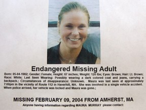 FILE - This Feb. 4, 2014 photo shows a missing person poster of Maura Murray that hangs in the lobby of the police station in Haverhill, N.H. Authorities are in an area of the northern New Hampshire town on Wednesday, April 3, 2019, related to an ongoing investigation into her disappearance in 2004.