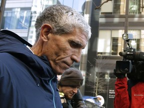 FILE - In this March 12, 2019, file photo, William "Rick" Singer founder of the Edge College & Career Network, departs federal court in Boston after pleading guilty to charges in a nationwide college admissions bribery scandal. Prosecutors allege Singer funneled millions of dollars from parents through his tax-exempt organization and then used it to pay coaches and other insiders to designate their children as athletic recruits or cheat on entrance exams,