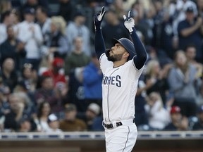 San Diego Padres' Eric Hosmer reacts after returning to the plate after hitting a solo home run against the Cincinnati Reds during the second inning of a baseball game in San Diego, Saturday, April 20, 2019.