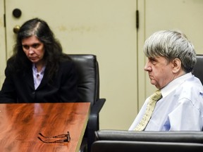FILE - In this Aug. 3, 2018 file photo, Louise Turpin, left, and her husband, David Turpin appear in Superior Court in Riverside, Calif. The Turpins, who starved a dozen of their children and shackled some to beds, face sentencing for years of abuse. The couple is due Friday, April 19, 2019, in Riverside County Superior Court for a proceeding that is largely a formality. The couple pleaded guilty in February to torture and other abuse and agreed to serve at least 25 years in prison.
