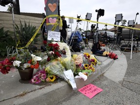 Flowers and signs sit at a memorial across the street from the Chabad of Poway synagogue, Sunday, April 28, 2019, in Poway, Calif. A man opened fire Saturday inside the synagogue near San Diego as worshippers celebrated the last day of a major Jewish holiday.