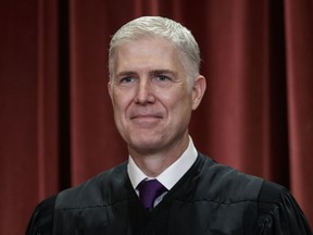 FILE - In this Nov. 30, 2018 file photo, Associate Justice Neil Gorsuch, appointed by President Donald Trump, sits with fellow Supreme Court justices for a group portrait at the Supreme Court Building in Washington. Supreme Court Justice Gorsuch has a collection of speeches, writings and original essays coming out this fall. Crown Forum, a conservative imprint at Penguin Random House, announced Wednesday, April 3, 2019, that Gorsuch's "A Republic, If You Can Keep It" is scheduled for Sept. 10.