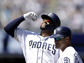 San Diego Padres' Fernando Tatis Jr. reacts after hitting a single in his first at-bat of his major leagues career, during the second inning of a baseball game against the San Francisco Giants, Thursday, March 28, 2019, in San Diego.
