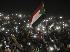 Sudanese protesters use their smartphones' lights during a protest outside the army headquarters in the capital Khartoum on Sunday, April 21, 2019. The organizers of Sudan's protests said Sunday they have suspended talks with the ruling military council because it has failed to meet their demands for an immediate transfer to a civilian government following the overthrow of President Omar al-Bashir.(AP Photo)