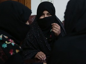 In this Monday, Feb. 18, 2019, photo, Alissa, who faced domestic violence, center, speaks during an interview with the Associated Press at a women's shelter office in Herat, Afghanistan. Women have made gains since the 2001 fall of the Taliban, but the country remains almost the worst places in the world to be a woman. Activists fear the advances they have achieved will be bargained away in negotiations, with pressure heavy for a deal as the United States seeks to end its military involvement in the country.