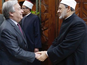In this photo released by Al Azhar, shows U.N. Secretary-General Antonio Guterres, left, shakes hands with Muslim cleric Sheikh Ahmed el-Tayeb, the grand imam, at the Al Azhar headquarters in Cairo, Egypt, Tuesday April 2, 2019. The U.N. chief has expressed solidarity with Muslims the world over during a visit to Cairo, denouncing hate speech and racism, as well as anti-Semitism. (Al Azhar via AP)