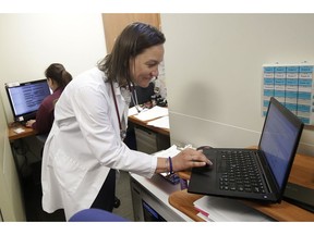 In this April 9, 2019 photo, Dr. Megan Mahoney types into a computer at the Stanford Family Medicine office in Stanford, Calif. "We want to do as much outside the walls of the clinic as we can," says Mahoney, noting that this push to keep patients healthy and out of the doctor's office depends on insurers expanding what they will cover.