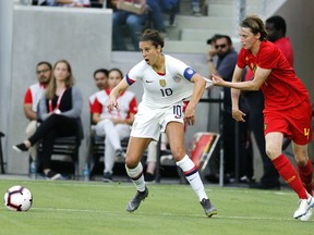 Belgium defender Heleen Jaques (4) grabs United States forward Carli Lloyd (10) during the first half of their international friendly soccer match Sunday, April 7, 2019, in Los Angeles.