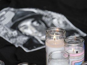 Candles appear at a makeshift memorial for rapper Nipsey Hussle in the parking lot of his Marathon Clothing store in Los Angeles, Monday, April 1, 2019. Hussle was killed in a shooting outside the store on Sunday.
