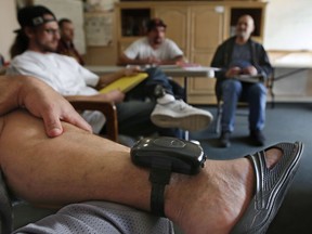 In this photo taken Wednesday, Feb. 20, 2019, a GPS bracelet is seen on the ankle of an inmate attending a discussion about living in sobriety at the Male Community Re-entry Program in Oroville, Calif. California's attempt to ease prison inmates transition back into the community is coming at a price, as an increasing number of prisoners simply walk away. Facilities like the one in Butte County, and in similar programs elsewhere are lightly guarded and inmates wear GPS bracelets that show their locations.